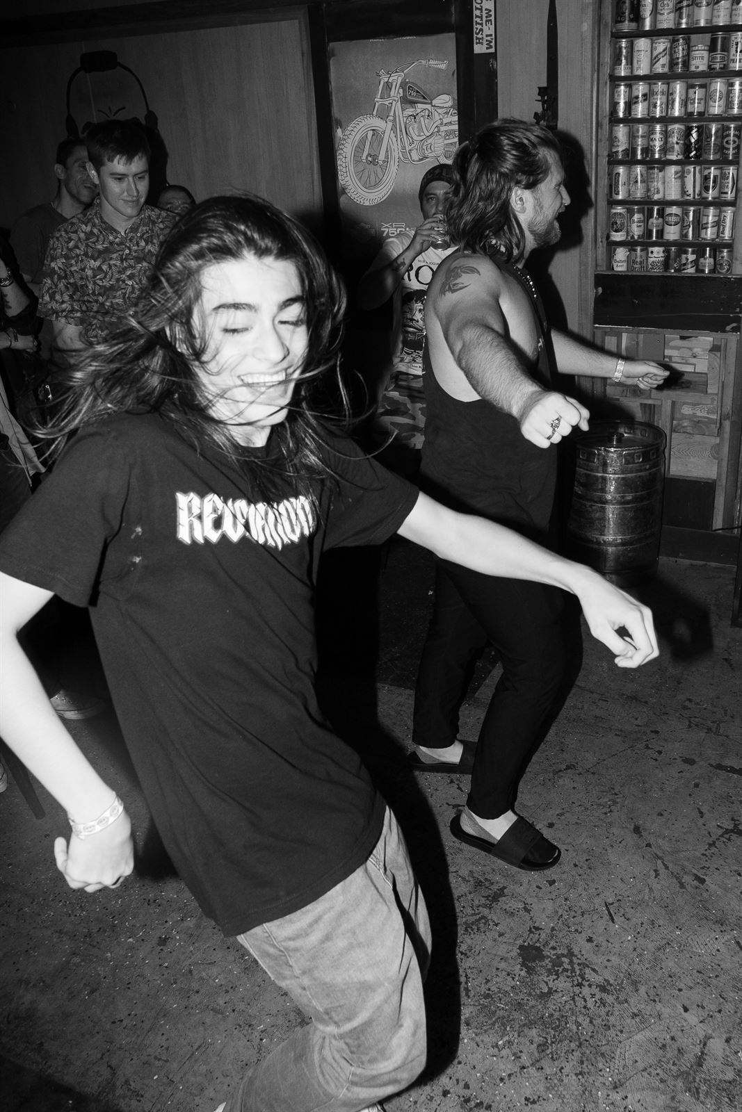 Dancers mid-motion at a bar show, black and white